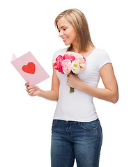 Image showing smiling girl with postcard and bouquet of flowers