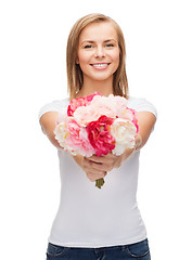Image showing smiling woman with bouquet of flowers