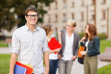 Image showing teenage boy with classmates on the back