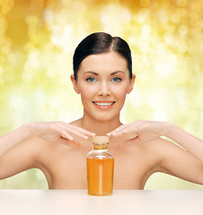 Image showing beautiful woman with oil bottle