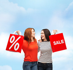 Image showing two smiling teenage girl with shopping bags