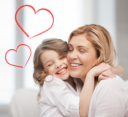 Image showing smiling mother and daughter hugging