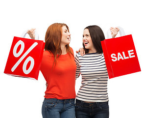 Image showing two smiling teenage girl with shopping bags