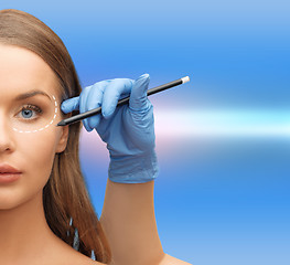 Image showing woman face and beautician hands