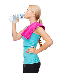 Image showing sporty woman with towel and watel bottle