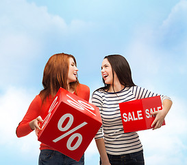 Image showing smiling teenage girl with percent and sale sign