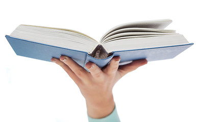 Image showing close up of woman hand holding open book