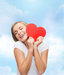 Image showing smiling woman in white t-shirt with heart