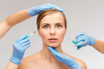 Image showing woman face and beautician hands with syringe