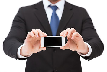 Image showing businessman showing smartphone with blank screen