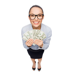 Image showing smiling businesswoman with dollar cash money