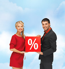 Image showing smiling man and woman with percent sign