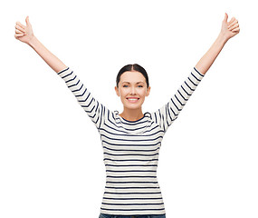 Image showing smiling girl in casual clother showing thumbs up