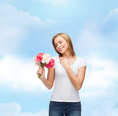 Image showing smiling woman with bouquet of flowers