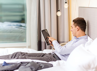 Image showing happy businesswoman with tablet pc in hotel room