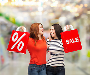 Image showing two smiling teenage girl with shopping bags