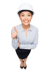 Image showing businesswoman in white helmet showing thumbs up