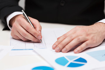 Image showing close up of businessman with papers