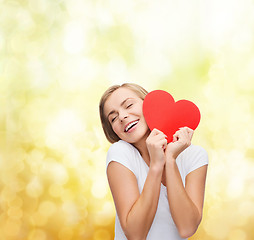 Image showing smiling woman in white t-shirt with heart