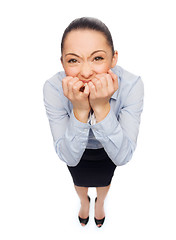 Image showing frightened businesswoman biting her fingers