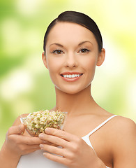 Image showing healthy woman holding bowl with sprout