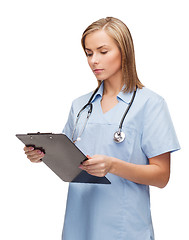 Image showing smiling female doctor or nurse with clipboard