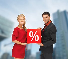 Image showing smiling man and woman with percent sign