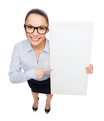 Image showing smiling businesswoman with white blank board