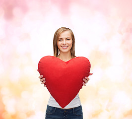 Image showing smiling woman in white t-shirt with heart