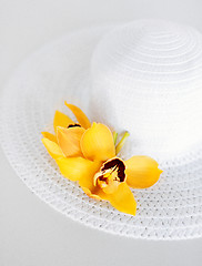 Image showing closeup of white hat and flowers