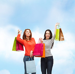 Image showing two smiling teenage girls with shopping bags