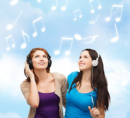 Image showing two smiling teenagers with headphones