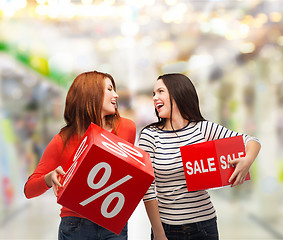 Image showing smiling teenage girl with percent and sale sign