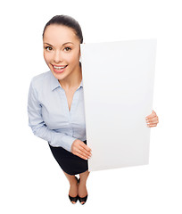 Image showing smiling businesswoman with white blank board