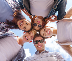 Image showing group of teenagers looking down