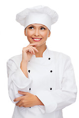 Image showing smiling female chef dreaming