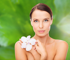 Image showing relaxed woman with orchid flower