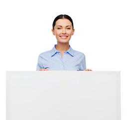 Image showing smiling businesswoman with white blank board