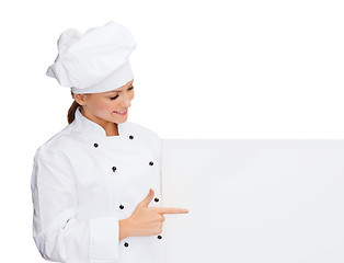 Image showing smiling female chef with white blank board