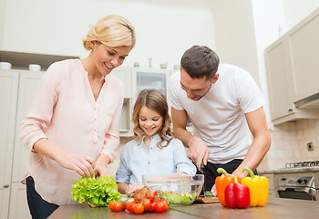 Image showing happy family making dinner in kitchen