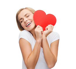 Image showing smiling woman in white t-shirt with heart