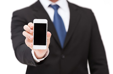 Image showing businessman showing smartphone with blank screen