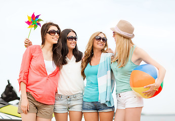 Image showing smiling girls in shades having fun on the beach