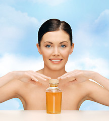 Image showing beautiful woman with oil bottle