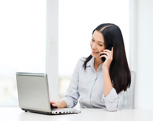 Image showing businesswoman with laptop and cell phone