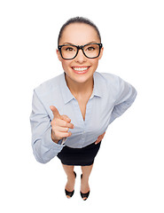 Image showing smiling businesswoman with finger up