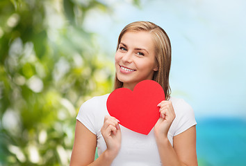 Image showing smiling woman in white t-shirt with heart