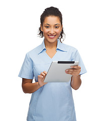 Image showing smiling black doctor or nurse with tablet pc