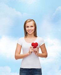 Image showing smiling woman in white t-shirt with heart