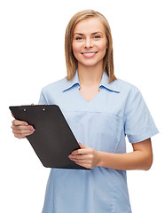 Image showing smiling female doctor or nurse with clipboard